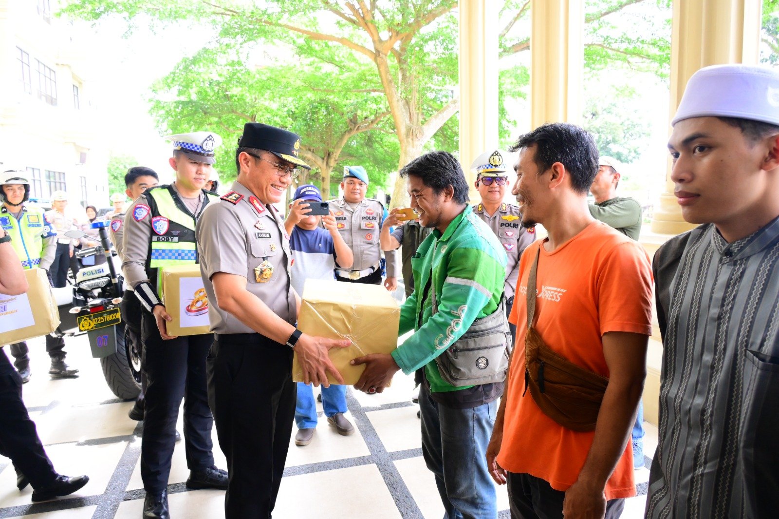 alt="Kapolda Jambi Irjen Pol Krisno H Siregar saat menyerahkan paket sembako secara simbolis kepada pengemudi ojek online di Lobby Mapolda"