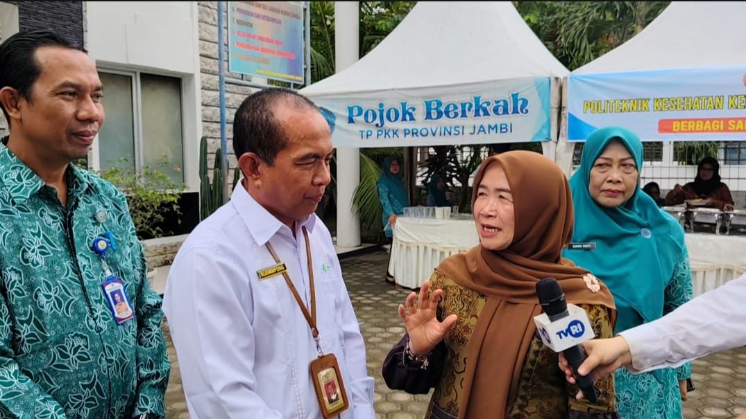 alt="Ketua TP PKK Jambi Hesti Haris memberikan kotak sarapan bergizi kepada warga di Telanaipura"